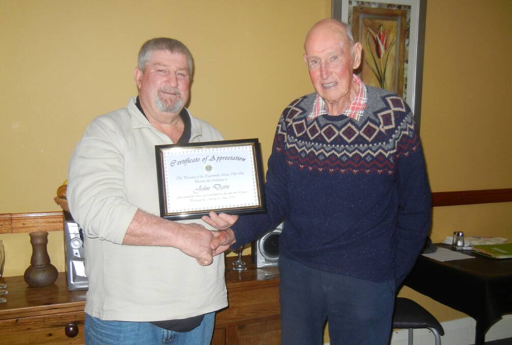 Lion John Davis, a Charter Member of the Canowindra Lions Club receiving a Certificate of Appreciation for 50 years Community Service from President Darryl Fliedner.