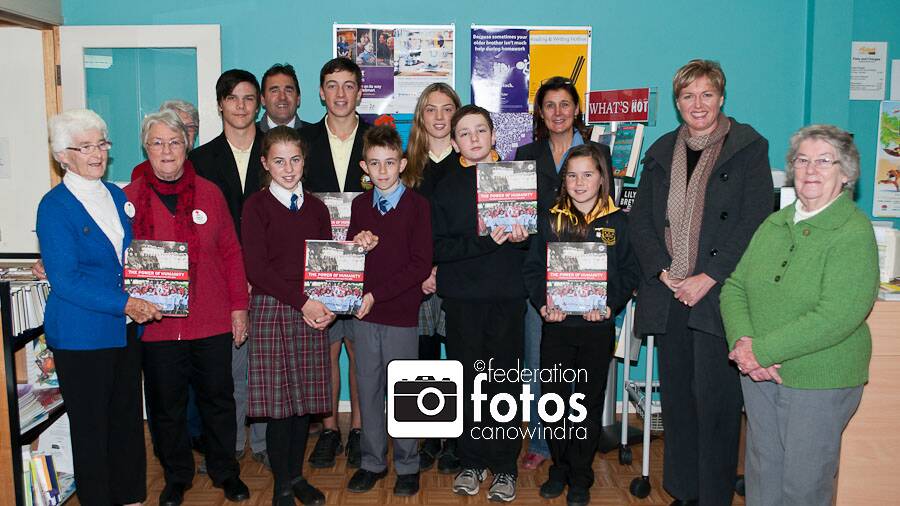 Red Cross members with the books presented to the local schools.
