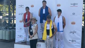 Lachlan Rice on the podium after finishing third in the under 21s Underhand Handicap final.