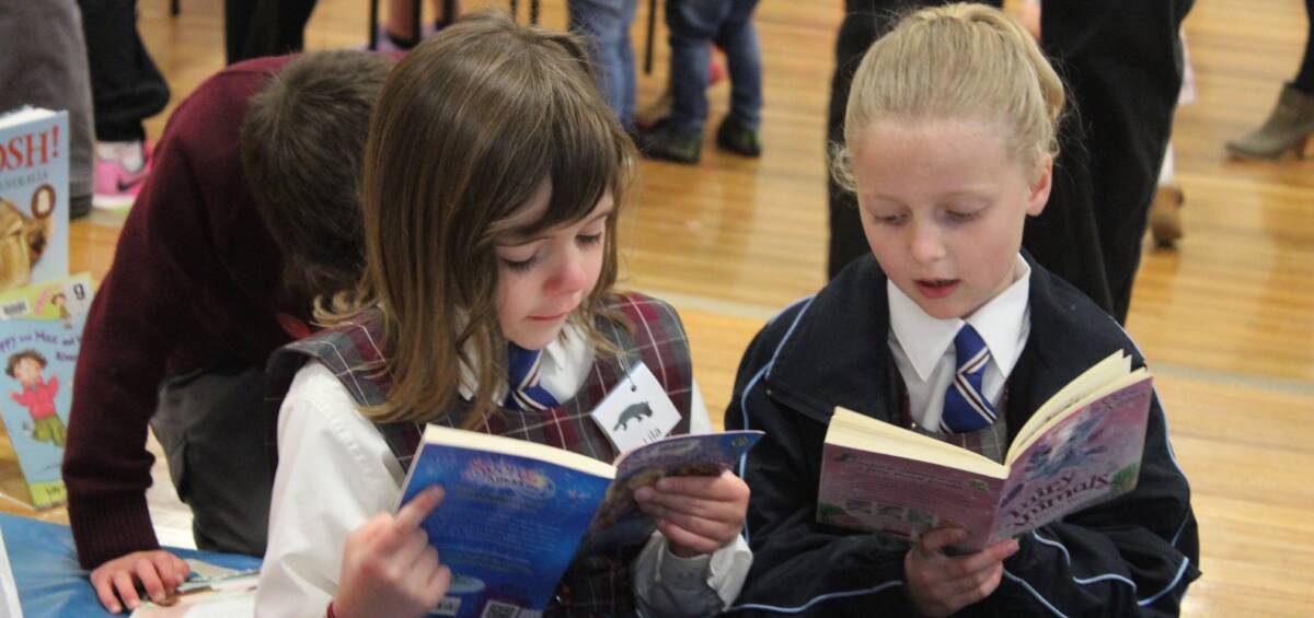 Lila Holloway and Anna Jobson read with each other during the Canowindra Community Reading Day at Canowindra Public School last week. 