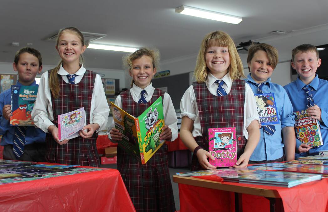 Year 4 students Bailey Kinsela, Izzy Brown, Harriet O'Dea, Laura Atkinson, Harry Hazelton and Toby Fisher with their favorite books from the fair. 