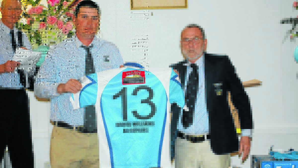 Adam Nash and John "Strapper" Hannan holding Chris Nobles jersey, No.13 at the Canowindra Pythons presentation night last year. Graham Rice in background.