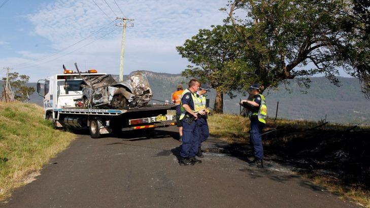 The mangled wreckage of the car is taken away after the fatal crash in Dapto. Photo: Sylvia Liber