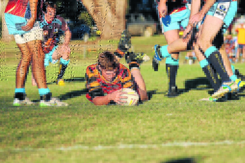 Kain Earsman, pictured scoring a try for the Canowindra Tigers on Saturday.