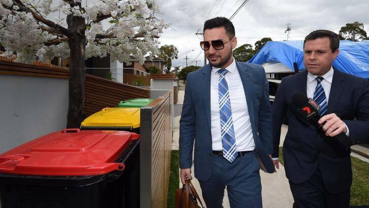 Salim Mehager questioned by a journalist outside his Lidcombe home on Tuesday. Photo: Kate Geraghty