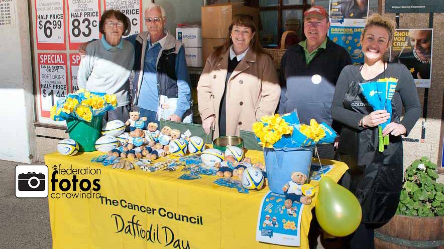 Jan Grimshaw, Robert Byrnes and Alena Hazelton all made a purchase from Margaret and Rob Morris (centre) in support of Daffodil Day last Friday. Photo by Federation Fotos.