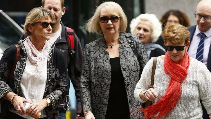 Liz Noble, left, the mother of Rozelle store explosion victim Chris Noble, arrives at court with supporters on Friday. Photo: Daniel Munoz