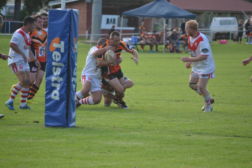 Matt Frazer is brought down by the Manildra Rhinos defence on Sunday afternoon at Tom Clyburn Oval. The Tigers won 44-16.