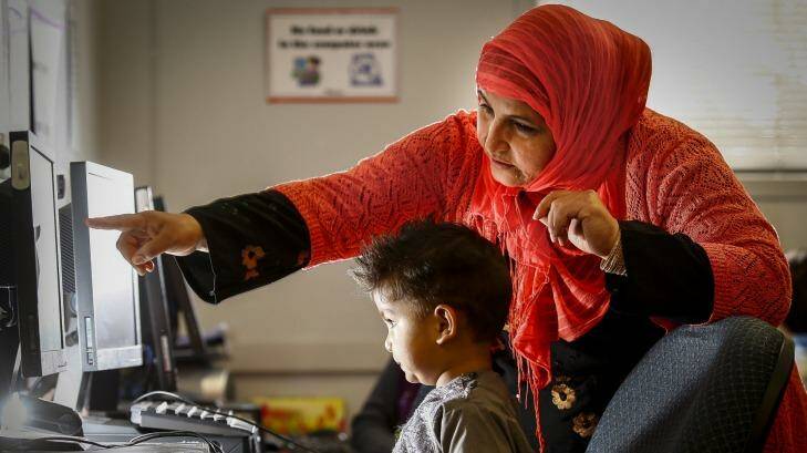Toorpaikai Baees with her son Arash during a program where Muslim mothers are taught IT skills so they can better understand what kids are looking at online – especially the risk of extremist propaganda. Photo: Eddie Jim