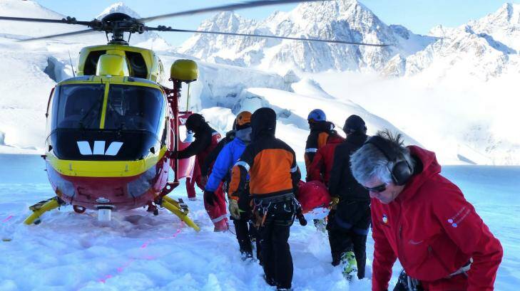 Rescuers and colleagues attend to the body of an Australian soldier killed on Aoraki Mount Cook in New Zealand. Photo:  Christchurch Press