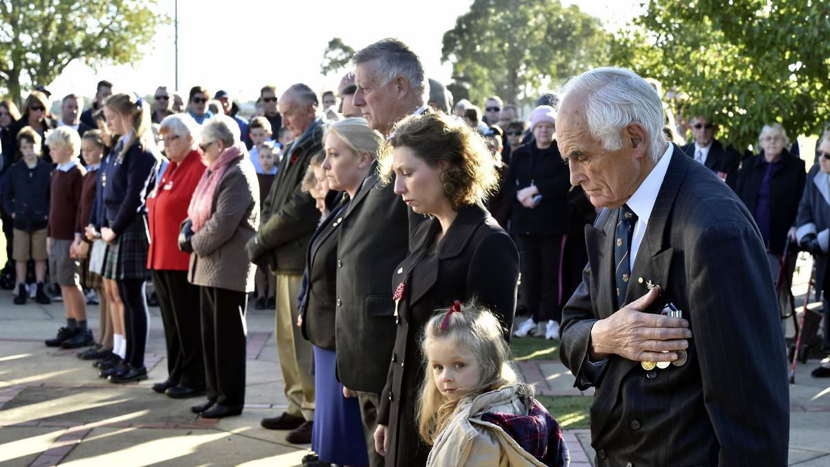 BALLARAT: People pause during the Anzac Day service at the Arch of Victory. Photo: Jeremy Bannister, The Courier. 