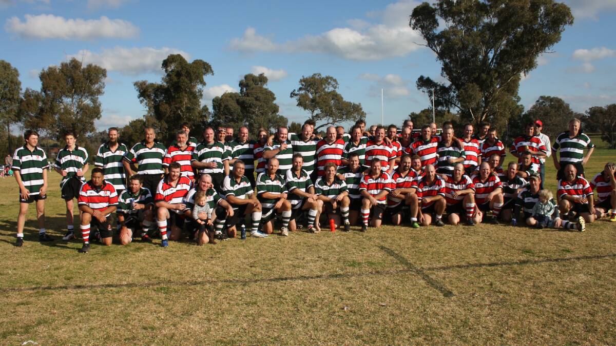 GREAT EFFORT: The 60 Cudal old boys pose for a group photo after playing a tribute match for fallen friend Ben Mitchell. Photo: MICHELLE COOK 0627mctribute3