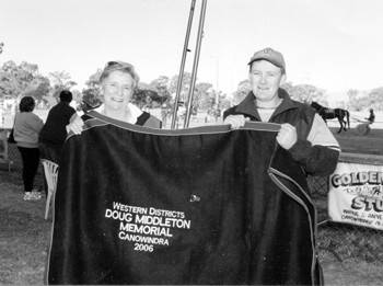 Pictured here is Jenny and Greg Middleton with the embroidered rug the Western Districts Harness Racing Association donated in memory of Doug Middleton, Jenny and children Janelle, Leanne, Loretta and Greg donated a new set off racing harness in memory of Doug.       Federation Fotos.