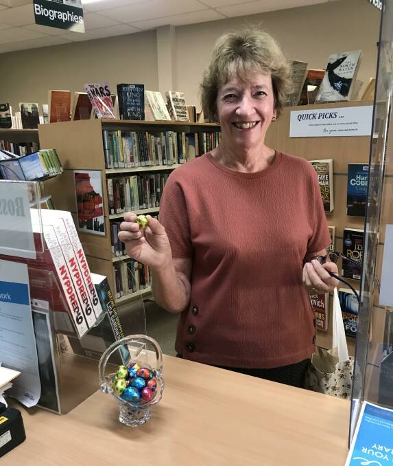 LOVE IS IN THE AIR: Patricia Rollinson selecting a chocolate for Library Lovers' Day celebrations.
