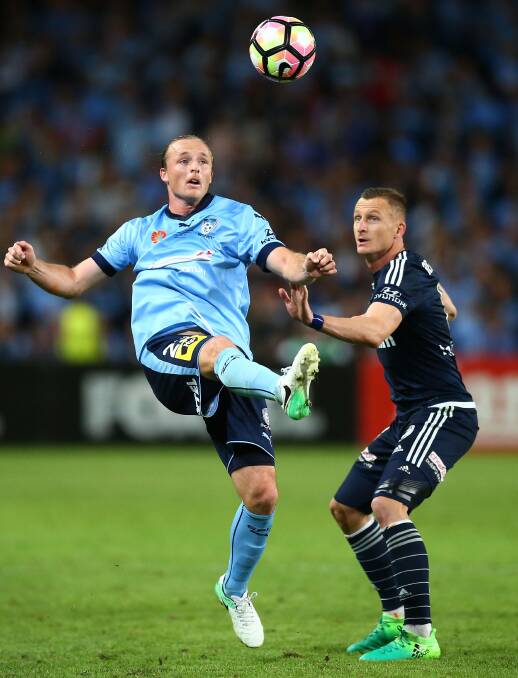 BIG NIGHT OUT: Sydney FC's Rhyan Grant clears the ball away from Melbourne Victory striker Besart Berisha. Both men scored in Sunday's A-League grand final. Photo: GETTY IMAGES
