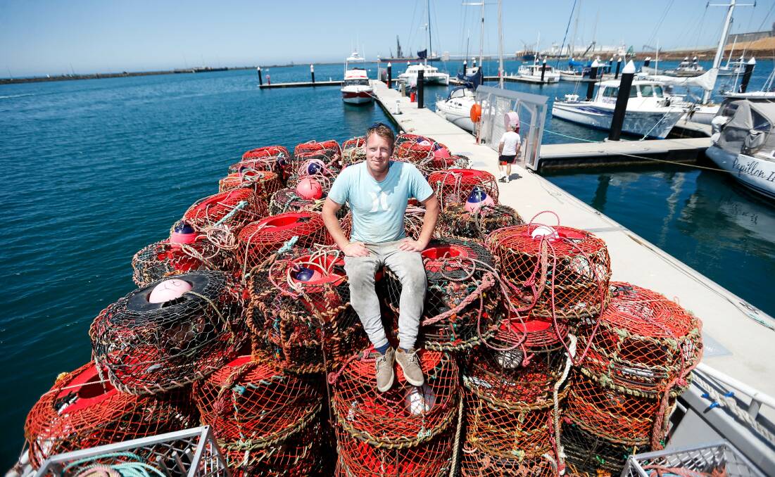 LIFELINE: Rock lobster fisher Callum McCarthy with empty cray pots in Portland, Victoria, after orders for the crustaceans were cancelled. The Victorian Government has since thrown a financial lifeline to lobster fishers, rolling over quotas until next year. Picture: Anthony Brady