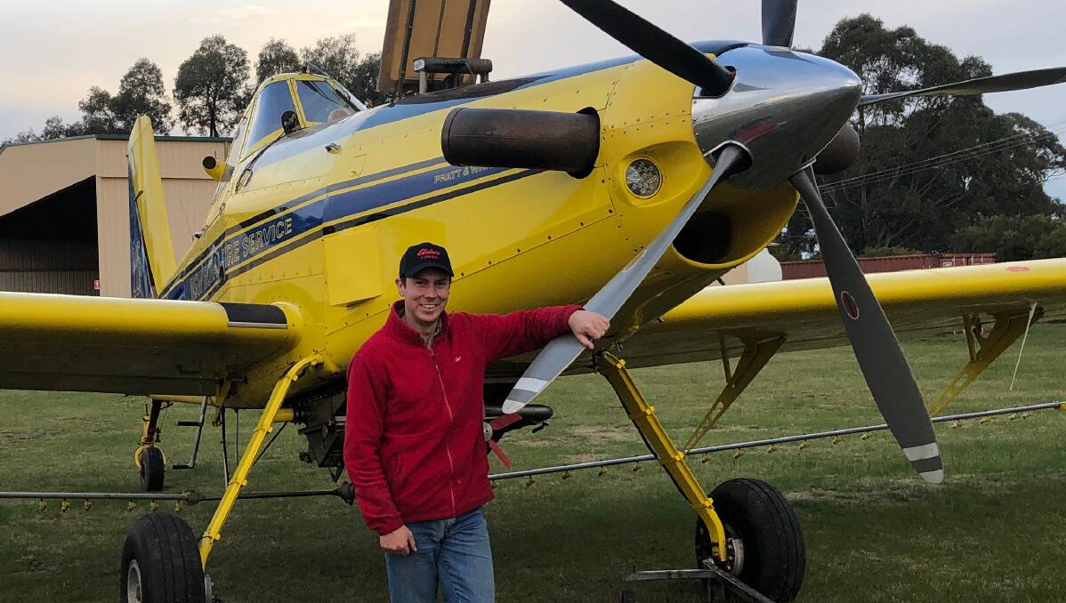 Elders agronomist Mitch Dwyer with one of six aircraft run by Fred Fahey Aerial Services, Cowra, working flat out over crops this wet winter.