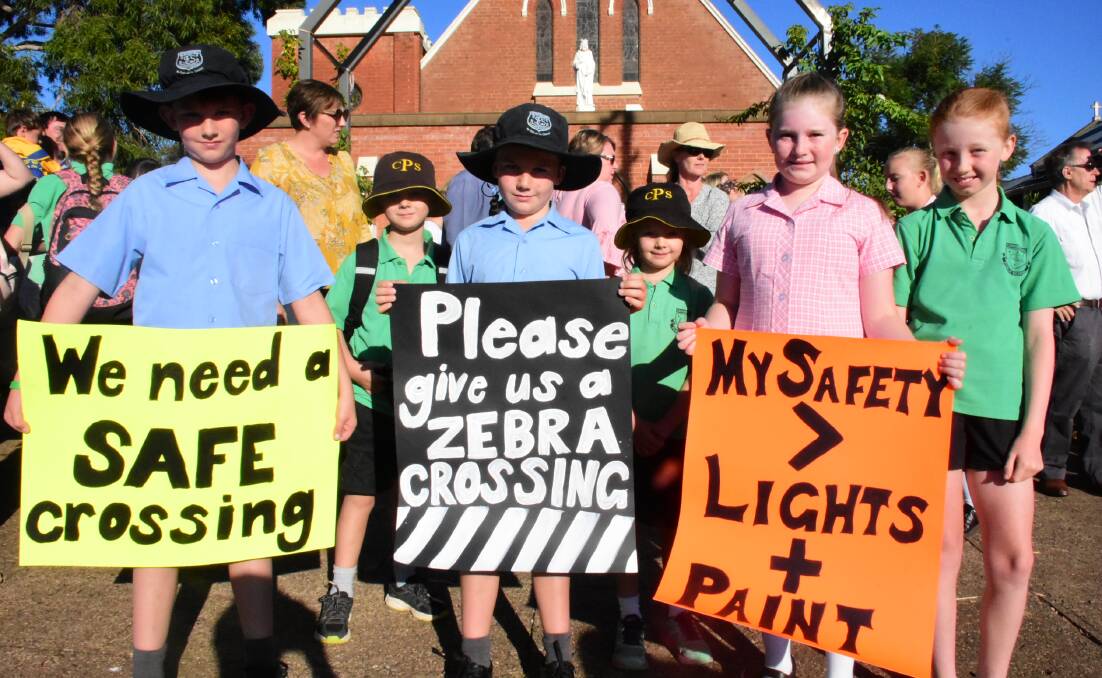 Kids made several signs for this week's protest at Tilga Street. Photo: Ben Rodin