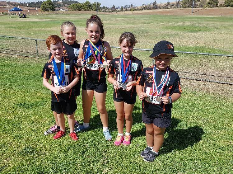 Thomas Phelan, Lila McCaffery, Sophie Phelan, Claire Phelan and Freya McCaffery at the Parkes Annual Little Athletics Carnival. Photo supplied by the Canowindra Little Athletics Centre.