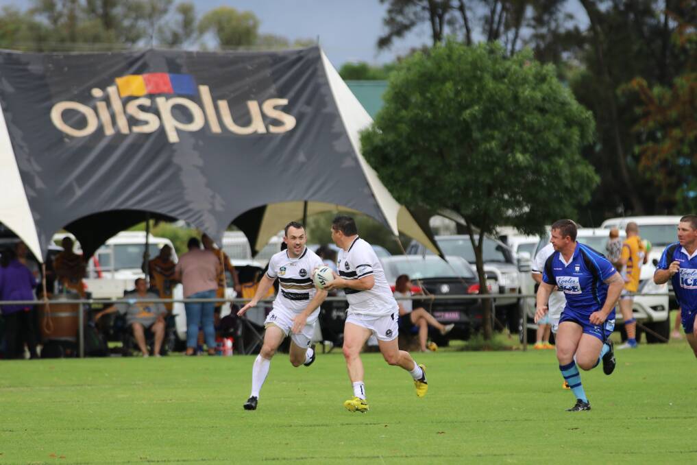 LEGENDS: Luke Goodwin looks to pass back on the inside to Bobby Wykamp for Eugowra, with Cargo's Anthony Redfern in pursuit. Photo: TAMMY GREENHALGH