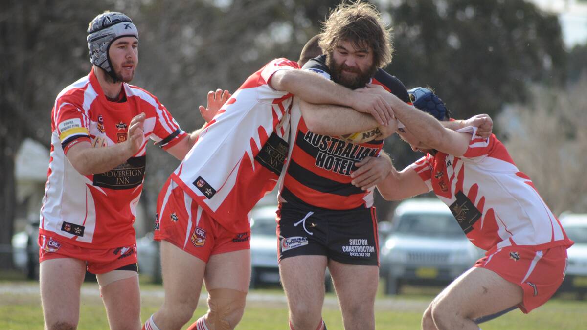 BEARS ARE BACK: Burrangong Bears Brett Campbell powers through the grasp of Gooloogong Cowboys players in 2015, the Bears are set to return.