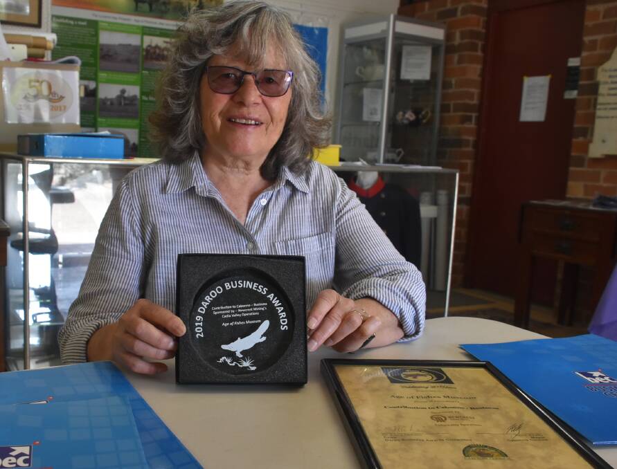 Age of Fishes Museum volunteer Jan O'Neill proudly displays the museum's Daroo Award. The museum won the category for Contribution to Cabonne by a Business.