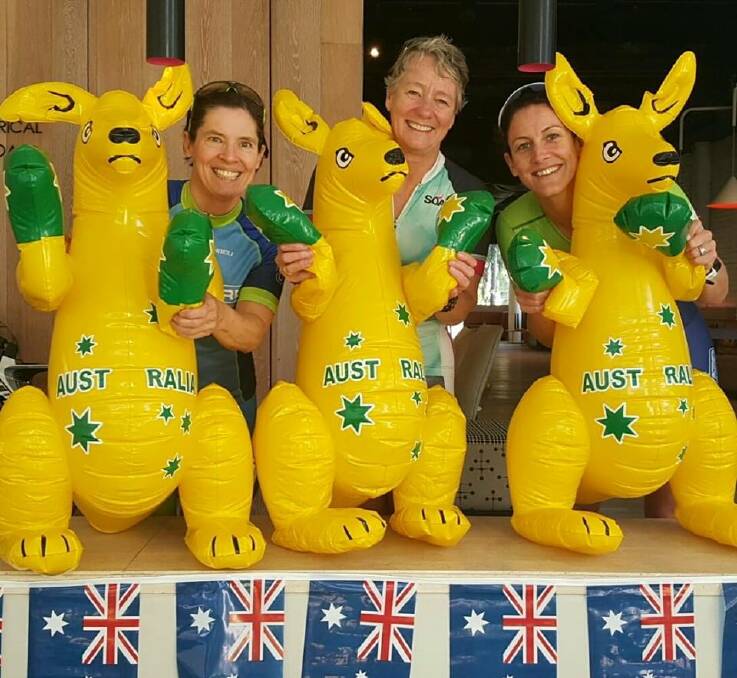 Julie Middleton with fellow Australian team members Cas Ingram and Kim Dale with the Aussie mascot at the ITU World Championships on the Gold Coast.
