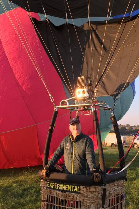 Happy being sky high: Adam Barrow will return home this month for the spectacle which is the Canowindra International Balloon Challenge. Photo: Federation Fotos
