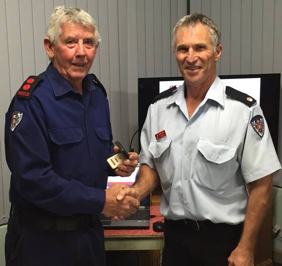 Bill Paul (left, pictured receiving his long service medal in 2013) recently celebrated 50 years in the Canowindra Fire and Rescue NSW. File photo. 