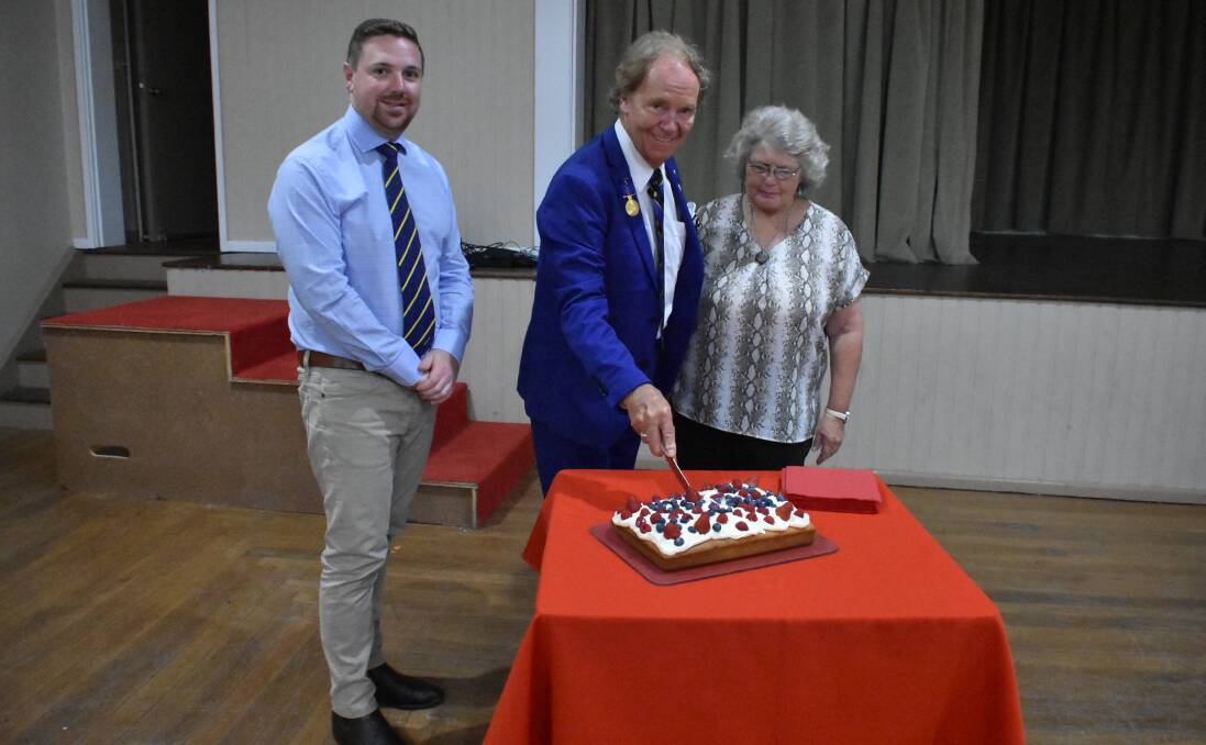Cr Jamie Jones, Tommy Jeffs and Debbie Ruttler cut the Australia Day cake. 