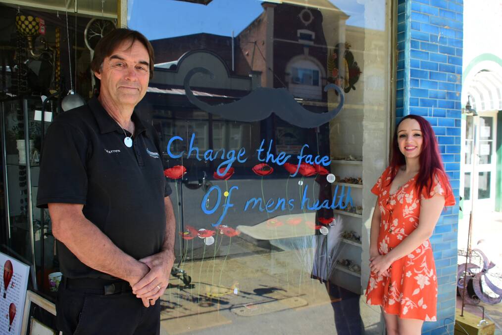 Warren Lawson and his daughter Jess Lawson from The Blue Bowerbird with their decorated window. 