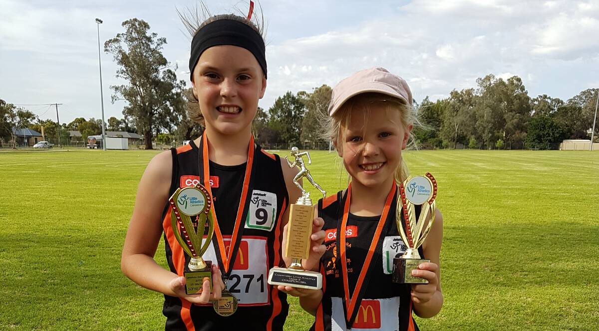 Sophie Phelan and Lucy Atkinson at the Canowindra Little Athletics Centre presentation with their age champion trophies.