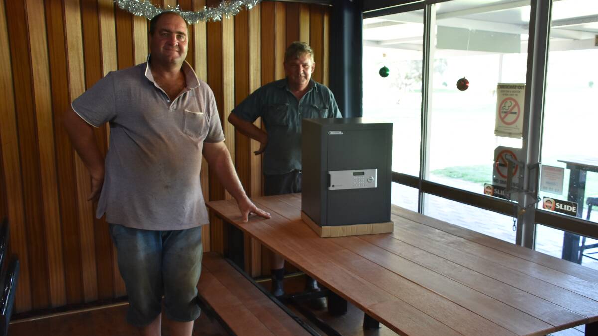 Canowindra Golf Club committee members Matt Devlin and Barry Rue with the safe and table and two bench seats to be auctioned.