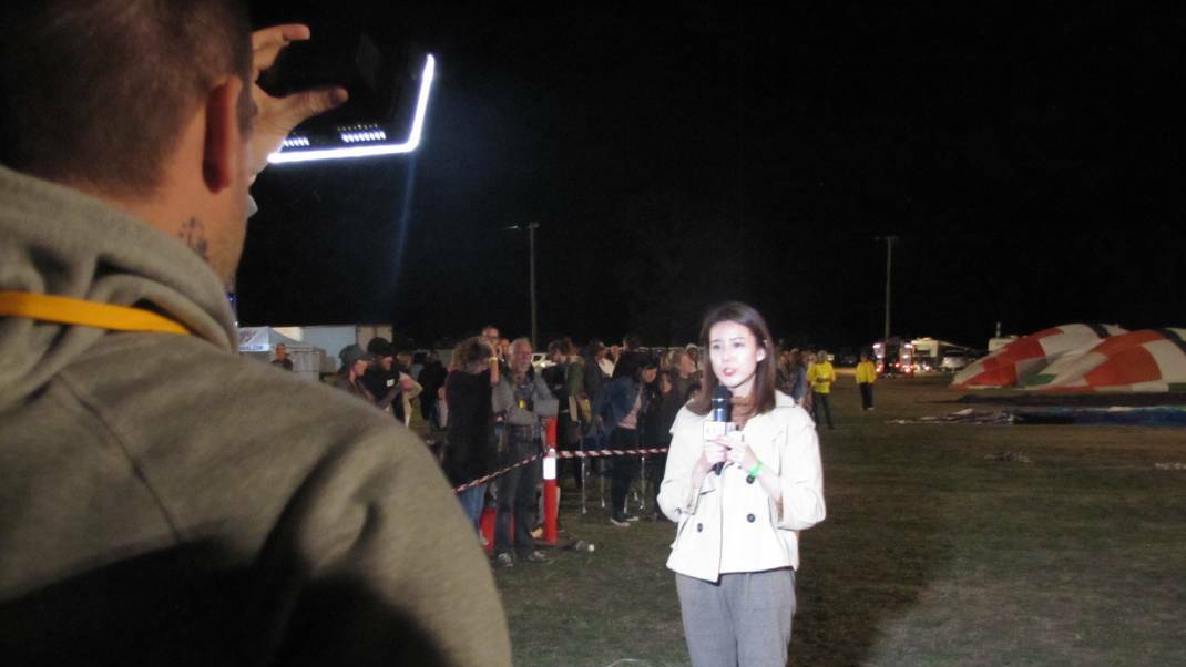 On-air talent from China’s Xinhua News Agency reporting live from Canowindra's Balloon Glow on the weekend. Photo: Cabonne Council
