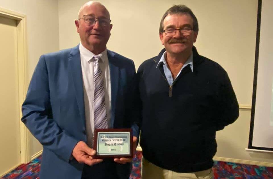 Roger Traves is presented with the NSW Poll Dorset Member of the Year award by Gordon Close.