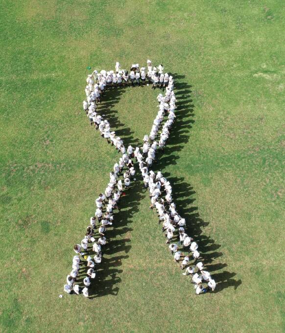 The Canowindra High School students forming the White Ribbon logo. Photo by Andrew Holmes.