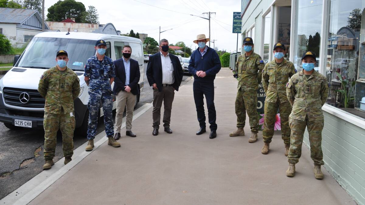 Deputy Mayor Jamie Jones, Mayor Kevin Beatty and Member for Calare Andrew Gee with members of the ADF assisting at the clinic. Photo by Federation Fotos.