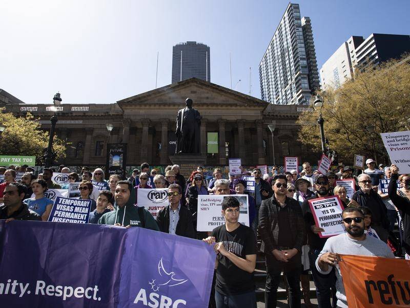 Demonstrators have gathered at the Victorian State Library in Melbourne to support refugee rights.
