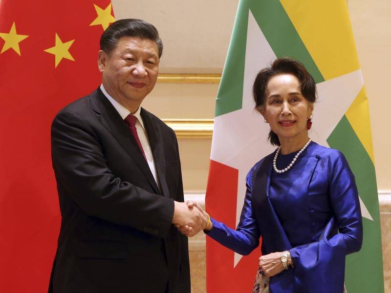 Myanmar's leader Aung San Suu Kyi shakes hands with Chinese President Xi Jinping.