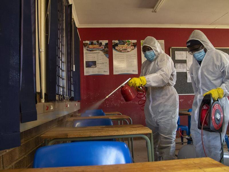 A disinfection team at work in a South African classroom ahead of schools reopening.