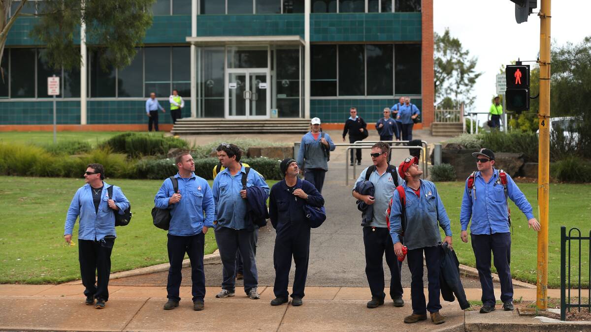 Holden workers moments after hearing the announcement that the Holden manufacturing plant in Elizabeth a suburb of Adelaide, South Australia, will be closing in 2017. Photo: KATE GERAGHTY