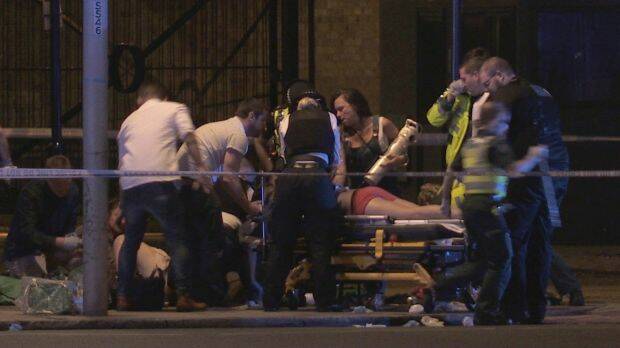 People receive medical attention in Thrale Street near London Bridge.  Photo: PA