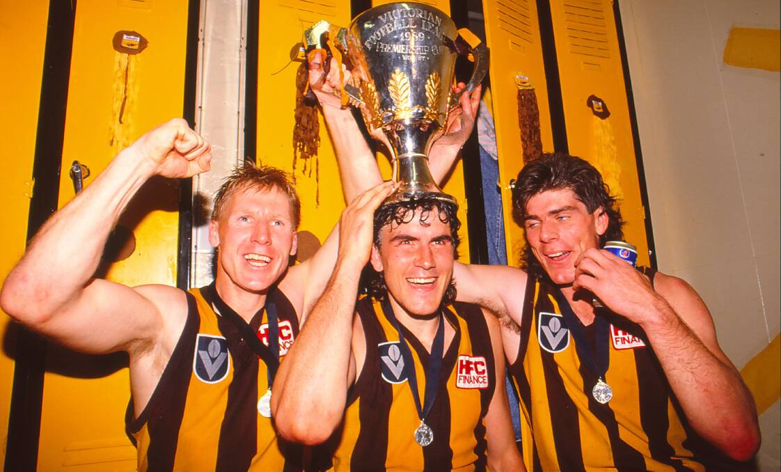 Hawthorn players celebrate the Hawks' 1989 premiership victory after beating Geelong in the AFL Grand Final match at the MCG. Photo: Getty Images