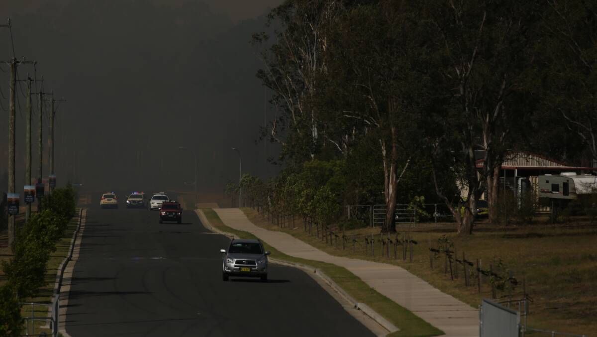 Ominous: Smoke cloaks part of the Coalfields as a bushfire rages at Greta. Picture: Simone De Peak