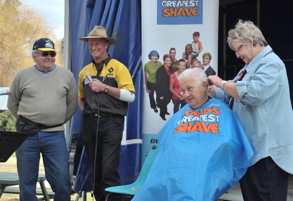 OVERACHIEVER: Russell Wicks and Brent Twaddel watch on as hairdresser Rose Lee cuts off Kathy Wicks' hair.