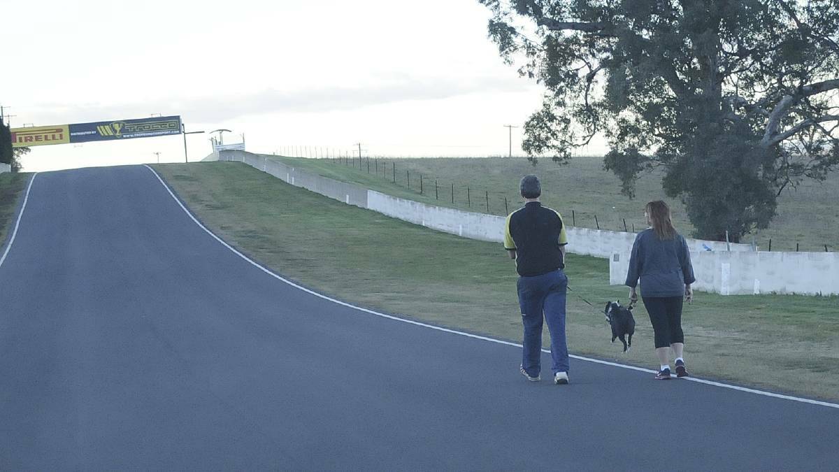 Walkers on the world-famous Mount Panorama, but be warned the circuit is a road when racing is not in progress and road rules do apply. Photo: CHRIS SEABROOK